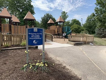 Park sign with flowers under it