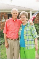 Senior Couple standing outside their home